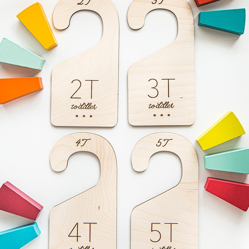 Four birch wood closet dividers etched 2T, 3T, 4T and 5T beside colorful wooden blocks